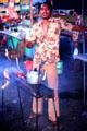 Street vendor grills skewers at Denpasar night market. Bali, Indonesia.