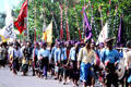 Religious procession with flags. Bali, Indonesia.