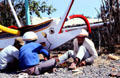 Boatmen work on boat painted with eye to ward off evil. Bali, Indonesia.